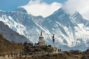 Nepal Gallery: Hoards of trekkers make their way to Everest Base Camp, Mount Everest is the peak on the left