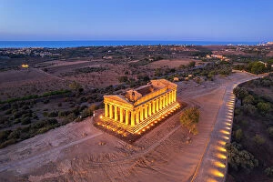 Tourist Attractions Collection: The illuminated Temple of Concordia seen from a drone at dawn, Valley of the Temples