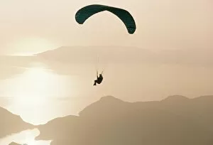Getting Away From It All Gallery: Man paragliding over the Mediterranean coast