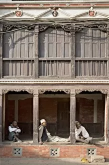 Seated Gallery: Three old men watch the world go by on a street in Bhaktapur
