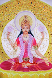 Shrine Collection: Picture of Lakshmi, goddess of wealth and consort of Lord Vishnu, sitting holding lotus flowers