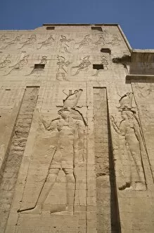 Temple Of Horus Collection: Relief depicting Horus on left, Pylon, Temple of Horus, Edfu, Egypt, North Africa, Africa