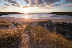 Lens Flare Collection: Ribbed sand and sand dunes at sunset, Crantock Beach, Crantock, near Newquay, Cornwall