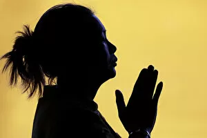 Tourist Attractions Collection: Silhouette of woman praying in temple, Faith and spirituality concept, Vietnam, Indochina