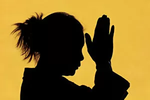 Tourist Attractions Collection: Silhouette of woman praying in temple Faith and spirituality concept, Vietnam, Indochina