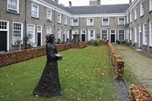 Court Yard Gallery: A statue of a nun stands in a courtyard of historic housing for women at the Begijnhof