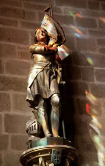 Female Likeness Gallery: Statue of St. Joan of Arc with coloured light from stained glass, Church of Notre Dame