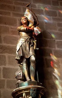 Female Likeness Gallery: Statue of St. Joan of Arc with coloured light from stained glass, Church of Notre Dame