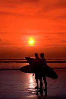 Jointly Gallery: Two surfers calling it a day, Kuta Beach, Bali, Indonesia, Southeast Asia, Asia