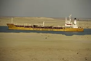 Egypt Collection: Tanker passing through Suez Canal with desert on either side, Egypt, North Africa, Africa