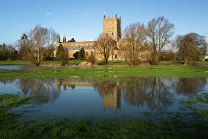 Tewkesbury Abbey reflected in flooded meadow, Tewkesbury, Gloucestershire, England