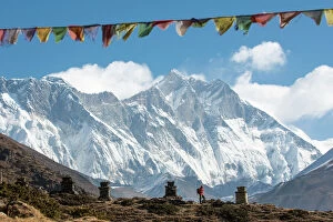 Nepal Gallery: A trekker on their way to Everest Base Camp, Mount Everest is the peak to the left