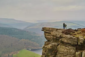 Getting Away From It All Gallery: Walkers taking in the view on Hathersage Edge, Ladybower Reservoir below, Peak District