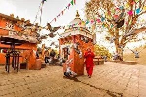 Kathmandu Valley Gallery: Woman walking and praying with pigeons at the hilltop temple, Bhaktapur, Kathmandu Valley