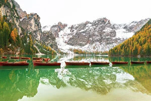 South Tyrol Collection: Wooden boats floating on calm waters of Braies lake, autumn view, Braies, South Tyrol