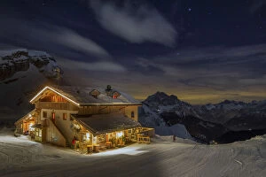 Overnight Collection: The Averau refuge in a wintertime night, surrounded by snow-covered peaks. Dolomites