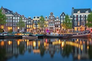 Tourist Attractions Collection: Boats moored in Singel canal near typical houses at twilight, Amsterdam, Netherlands