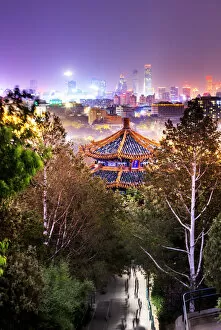 Pagoda Collection: China, Beijing, pagoda and skyscrapers in the background illuminated by city lights