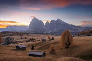 Tourist Attractions Collection: The lonely cabins of the Alpe di Siusi (Seiser Alm) during a peaceful autumn morning