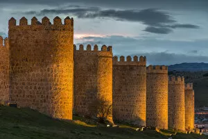 The medieval city walls illuminated at dusk, Avila, Castile and LeAA³n, Spain