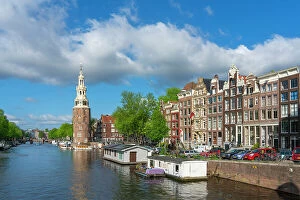 Tourist Attractions Collection: Montelbaanstoren tower by Oudeschans canal against sky, Amsterdam, North Holland, Netherlands