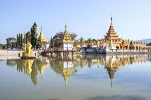 Pagoda Collection: Myanmar, Hsipaw. Buddhsit pagodas reflected into small lake