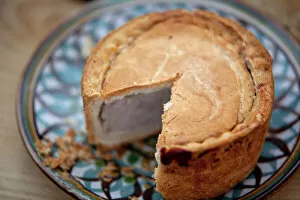 Garden Collection: Nottinghamshire, UK. Melton Mowbray pork pie on handmade ceramic plate
