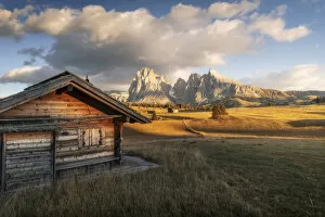 Tourist Attractions Collection: An old cabin lost in the meadows of the Alpe di Siusi (Seiser Alm) during an early autumn sunset