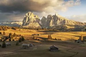 Tourist Attractions Collection: Some old cabins lost in the meadows of the Alpe di Siusi (Seiser Alm) during an early autumn sunset