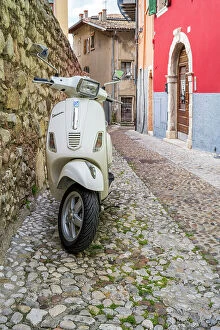 Lake Garda Collection: Piaggio Vespa scooter parked in a cobbled street of Malcesine, Lake Garda, Veneto, Italy
