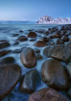 Tourist Attractions Gallery: Rocks into the water at Uttakleiv beach at twilight, Leknes, Lofoten, Nordland, Norway