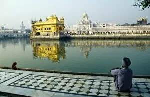 Temples Collection: A Sikh pilgrim pauses for reflection by Amrit Sarovar