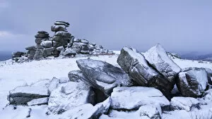 Snow covered granite rocks at Great Staple Tor, Dartmoor, Devon, England. Winter
