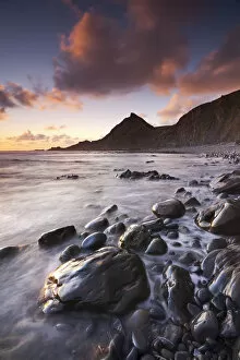 Sunset on the shoreline of Spekes Mill Mouth beach in North Devon, England