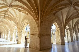 A tourist observes the columns of the cloister of the Mosteiro dos Jeronimos