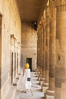 Nubia Collection: toursit walking through the Temple of Philae on an island in Lake Nasser, Nile River