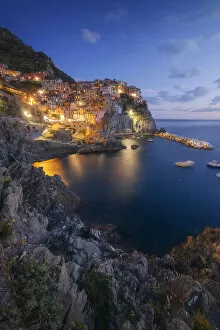 Tourist Attractions Collection: Twilight in Manarola, Cinque Terre, the most beautiful moment of the day when the lights of