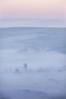 Widecombe-in-the-Moor Church surrounded by mist at dawn, Dartmoor National Park, Devon