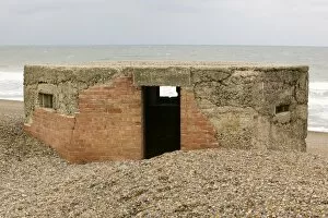 Coastal Erosion Collection: A 2nd World War bunker on the beach at Cley Norfolk UK