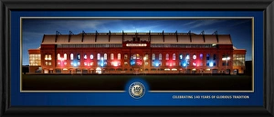 <b class=qtipBold><figcaption>Ibrox at Night Framed Panoramic</figcaption></b><br>A fantastic framed panoramic photograph of Ibrox at night, in celebration of 140 years of glorious history. Ibrox Stadium is a football stadium located on the south side of the River Clyde in the Ibrox district of Glasgow. Ibrox is the third largest football stadium in Scotland, having an all-seated capacity of 50, 987. Ibrox is best known for being the home ground of Rangers FC. It was opened as Ibrox Park in 1899. Vast earthen terraces were built in its place, while a main stand, which is now a listed building, was built in 1928. A British record crowd of 118, 567 gathered in January 1939 for a league match with Celtic. After 1971 the stadium was largely rebuilt. The vast bowl-shaped terracing was removed and replaced by three rectangular, all-seated stands by 1981. After renovations were completed in 1997, the ground was renamed Ibrox Stadium. The Ibrox pitch is surrounded by four covered all-seater stands, officially known as the Bill Struth Main (south), Broomloan (west), Govan (north) and Copland Road (east) Stands. Each stand has two tiers, with the exception of the Bill Struth Main Stand, which has had three tiers since the Club Deck was added in 1991. The two corner areas, known as the West and East areas of the Govan Stand, have one tier of seating below a JumboTron screen. Ibrox has also hosted the Scotland national football team, particularly when the national stadium Hampden Park was redeveloped in the 1990s. Ibrox also hosted three Scottish domestic cup finals in the same period. It has also been the venue for concerts by major performers, including Frank Sinatra. RANG602 (30") RANG603 (Desktop)<br><em>© Rangers FC</em> Ibrox at Night Framed Panoramic