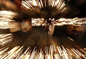 Oil Lamp Collection: Buddhist devotees light oil lamps at Gangaramaya temple as part of celebrations for the