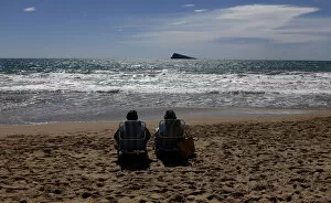 Leisure Time Collection: A couple relaxes as they sunbath on a beach during a sunny day in Benidorm