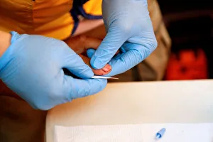A paramedic takes a blood sample for DNA testing from a resident looking for a relative A paramedic takes a blood sample for DNA testing from a resident looking for a relative