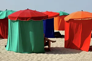 Getting Away From It All Gallery: A woman relaxes on the beach at Deauville