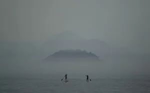 Leisure Time Collection: Two women paddle on stand up paddle boards at Copacabana beach in Rio de Janeiro