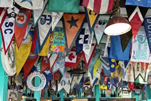 Bahamas Collection: Bahamas, Exuma Island. Flags on ceiling of bar at Yacht Club