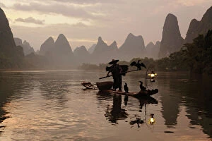 Sun Rise Gallery: Traditional Chinese fisherman with cormorants on Li River at sunrise, near Guilin, China