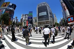 People crossing the pedestrian crossing at the intersection in Shibuya, Tokyo, Japan