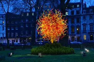 The Sun glass sculpture by Dale Chihuly comes out at night in Berkeley Square, London