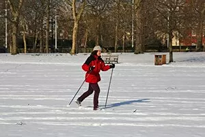 A woman on skis in the snow in St James Park, London